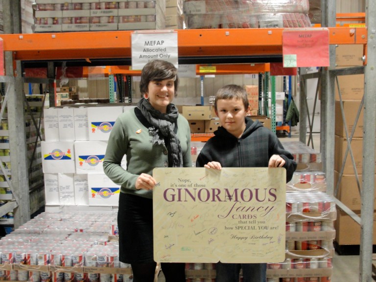 Alex visits the Food Bank and shows off his birthday card